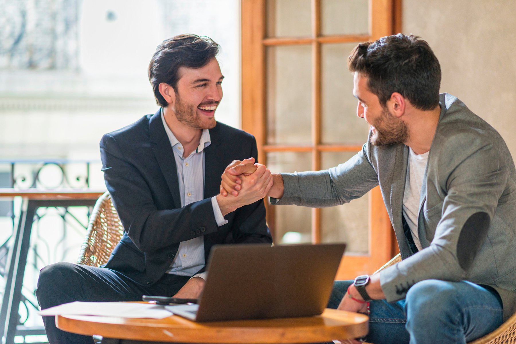 Young Latin American businessmen celebrating success